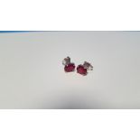 A PAIR OF TREATED RUBY SILVER STUDS