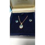 A 9 CT GOLD AND BLUE STONE SET PENDANT WITH MATCHING EARRINGS