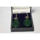A PAIR OF OVAL SHAPED PATTERNED JADE DROP EARRINGS SET WITH DIAMONDS AND INLAID WITH BLACK ENAMEL,