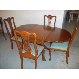 A REPRODUCTION DROP LEAF PEDESTAL DINING TABLE WITH FOUR CHAIRS WITH CABRIOLE LEGS