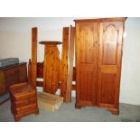 A SOLID PINE DUCAL WARDROBE AND A DOUBLE PINE BED FRAME, TOGETHER WITH A BEDSIDE CUPBOARD