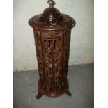 A DECORATIVE CAST CYLINDRICAL STAND ALONE LOG BURNER