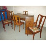 A WALNUT EXTENDING DINING TABLE WITH FOUR CHAIRS TOGETHER WITH TWO MATCHED CHAIRS ALL WITH