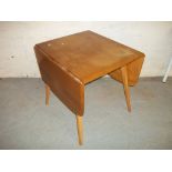 AN ERCOL DROP LEAF DINING TABLE