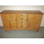 A RETRO OAK SIDEBOARD WITH PANELLED DOORS MADE BY REYNOLDS OF LUDLOW