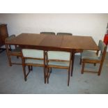 A RETRO TEAK EXTENDING DINING TABLE AND SIX SWIVEL BACKED DINING CHAIRS