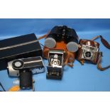 A PAIR OF BINOCULARS , A EUMIG SUPER-8 CAMERA, A KODAK FOLDING CAMERA ETC.