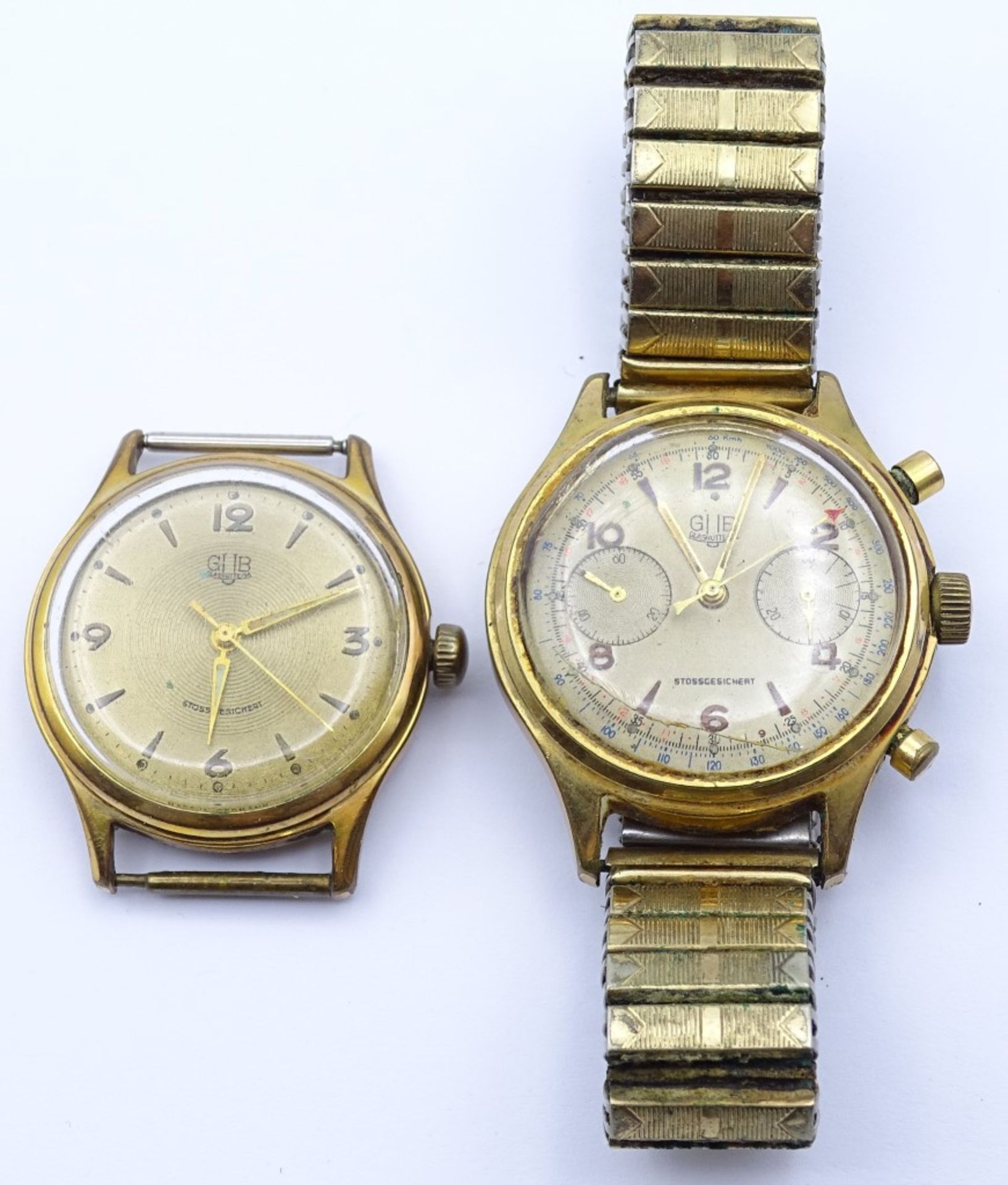 Zwei Armbanduhren "GUB",beide mechanisch,Werke laufen,vergoldet,Alters-u. Gebrauchsspuren, d-33-