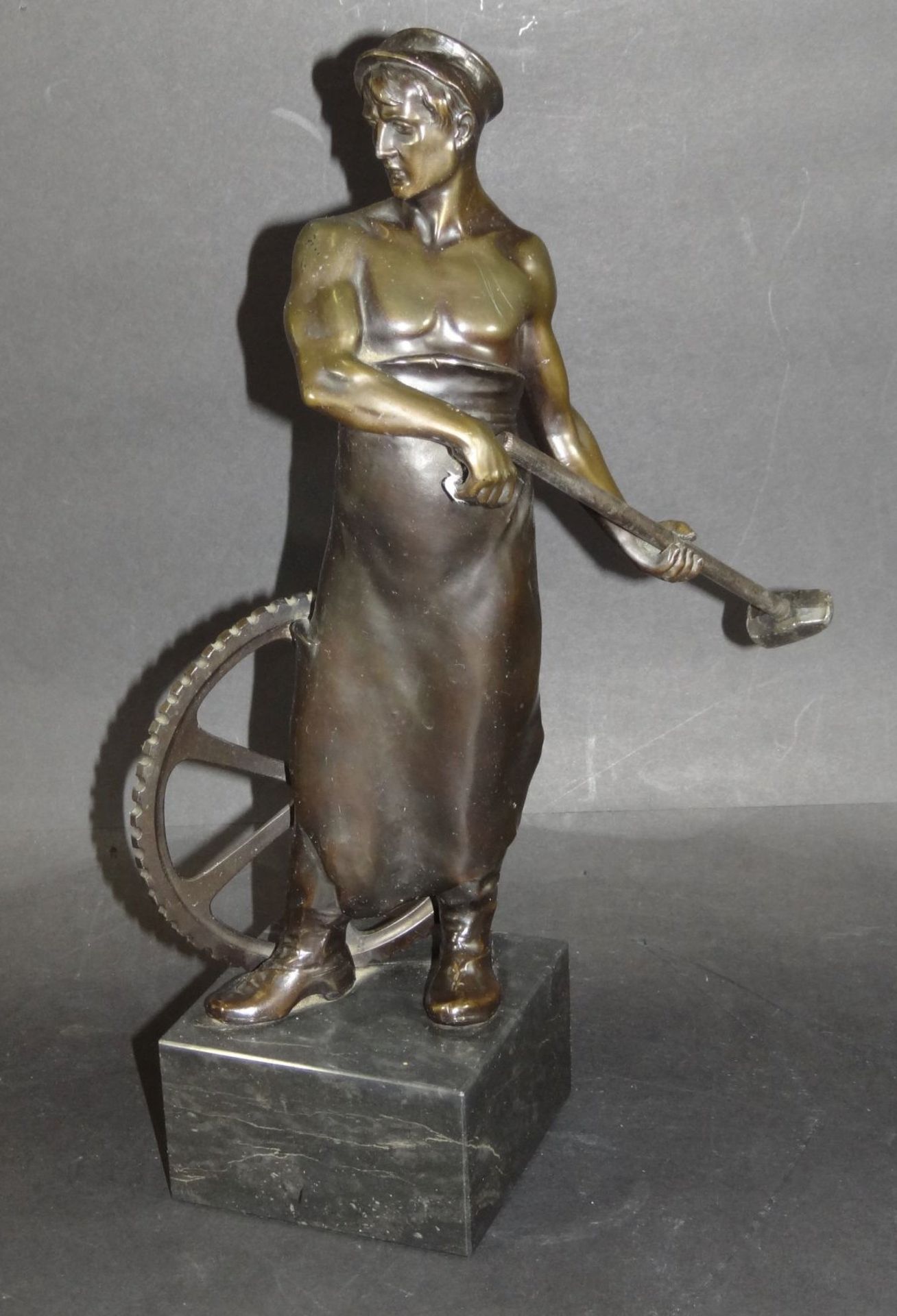 Zinkguss-Figur eines Metallarbeiters auf Steinsockel, H-32 cm