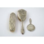 Lot of two brushes in pig bristle and silver and a small silver mirror,