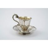 Engraved silver cup and saucer