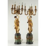 Pair of wooden sculptures depicting girls holding four-light candelabra
