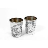 Pair of 800 silver shot glasses Italy, '50, smooth body decorated with plant motifs, vermeil