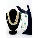 Lot of two necklaces manifacture contemporary, one in river pearls and seven-wire gilded metal and