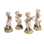 Lot of four polychrome ceramic playing putti manifacture napoletana, mid 20th century, marked N
