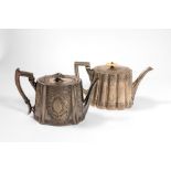 Lot of two silver metal teapotsInghilterra, late 19th century, smooth bodies richly engraved with