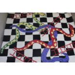 A rug with snakes and ladders design
