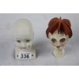 A lot: one bisque doll's head with teardrop and two painted clay heads