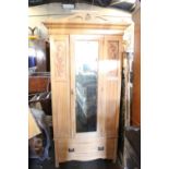 Pine wardrobe, decorative carved front, mirrored door and deep drawer to base