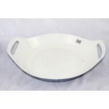 A lot: a large blue enamelled cast iron cooking dish made by Copco; a large blue, oval cooking dish;