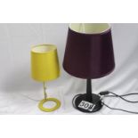Two modern table lamps. Both in working order. One dark stained wood base with purple shade; the