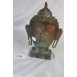 Bronze Buddha head mask on marble base