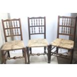 Five antique oak spindle-backed country chairs, two with rush seats and 3 with sisal. Some