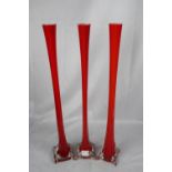 Three unusual and very striking red glass vases, height 60cm
