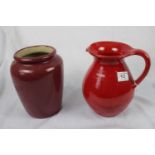 A lot; large red pottery jug and a deep red pottery vase, ht 20cm