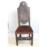 A very beautiful antique carved oak 'throne' chair with ornately tooled leather and studded seat