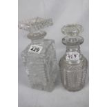 Two cut glass decanters, one square with square stopper, one bulbous with round stopper, both in