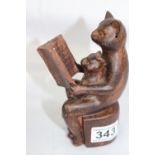 A very appealing clay figurine of two cats reading