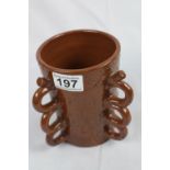 Brown pottery three-handled pot