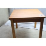 A modern square pine coffee table. Measures 49cm H x 55cm W x 55cm D x