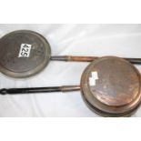 Two antique warming pans, one copper and one brass