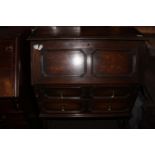 Early 20thC oak fall front bureau with two drawers and writing compartments, plain stretcher base,