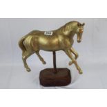 Gilded carved wood horse on stand