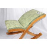 A green upholstered vintage rocking footstool