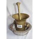 A lot: antique solid brass pestle and mortar; a brass deep saucer with decorative floral rim and