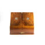 An Edwardian walnut stationery box of Cambridge University interest with sloping front, the twin