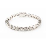 An unusual tennis bracelet set with seventeen round brilliant cut diamonds total estimated diamond