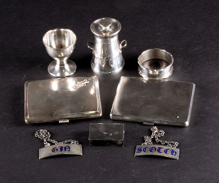 A mixed group of small silver items comprising two cigarette cases, a pepper modelled as a milk
