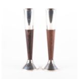 Cartier: A pair of polished wood and white metal candlesticks stamped Cartier Sterling Weighted,