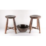 A near pair of provincial oak stools each on four legs, united by an X-stretcher, 43 cm high,