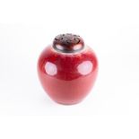 A Chinese Qing dynasty sang de boeuf porcelain jar of globular shape with ox blood red glaze