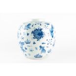 A Chinese blue and white ginger jar decorated with goldfish and marine plants, 22 cm high.