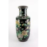 A Chinese late Qing dynasty famille noire porcelain vase in the rouleau shape decorated with applied