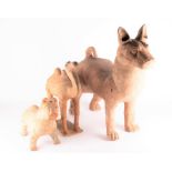 Two Han dynasty style terracotta models of dogs to include a large scale model with looped tail,