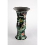 A Chinese Qing dynasty famille noire  'gu' vase probably late Kangxi period, decorated with