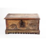 An early 18th century painted trunk with cast iron mounts and key, decorated to the outer and